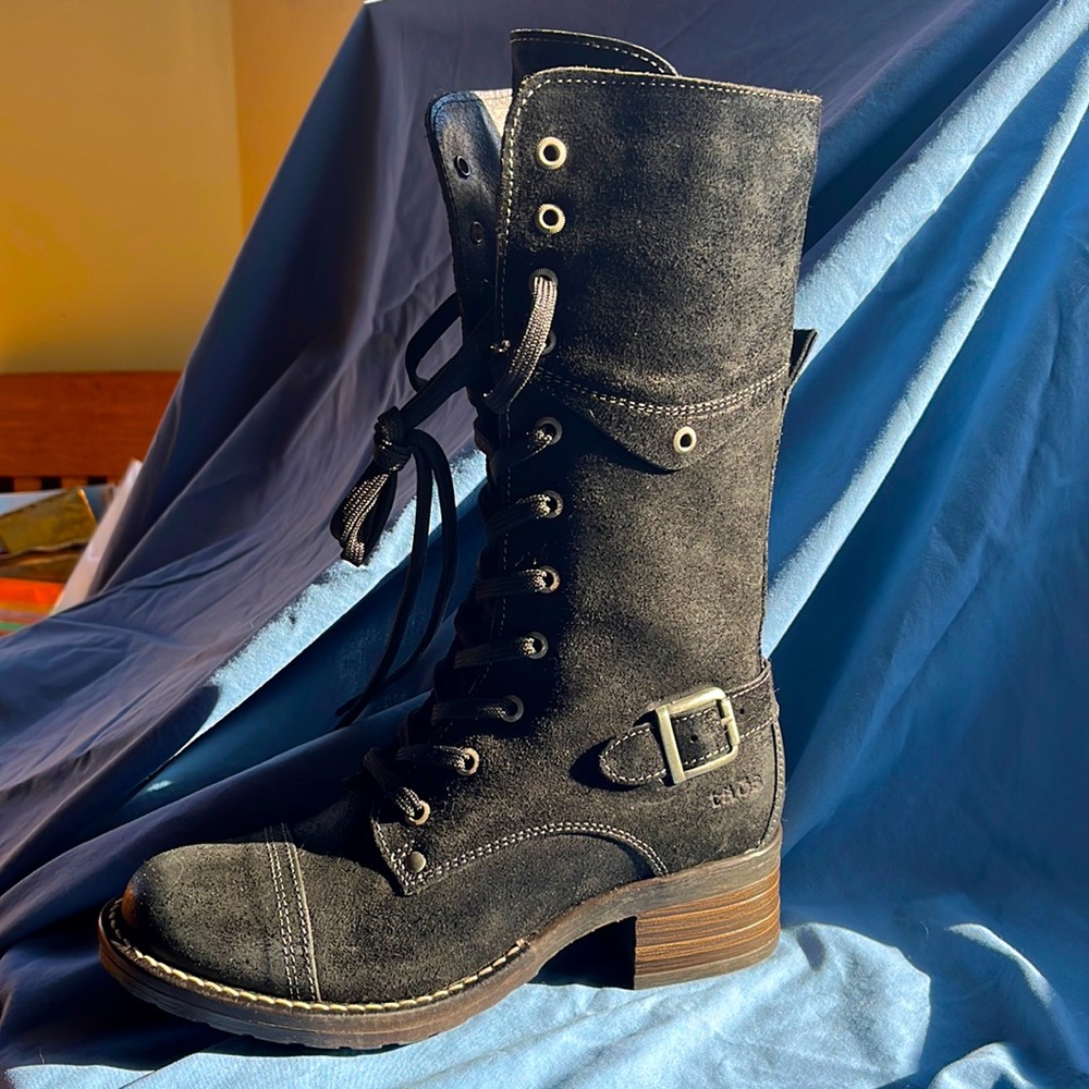 TAOS black leather boots. NEVER WORN! One boot is still tied from the store!